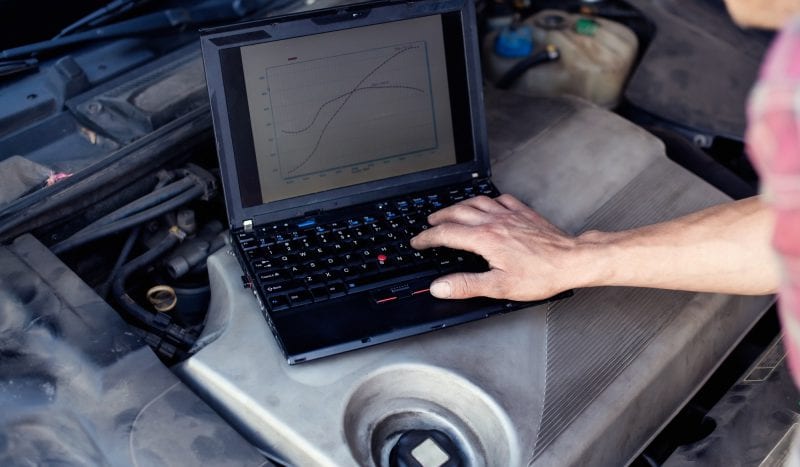 Car mechanic with laptop